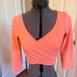 Bebe pale salmon cross front top